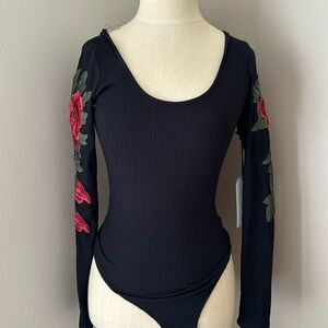 Black backless bodysuit with red flowered sleeve